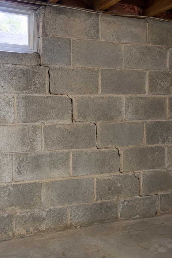 Stair-step crack following mortar joints in a concrete block foundation wall