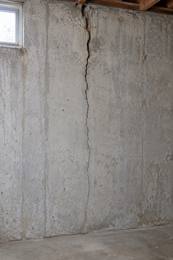 Vertical foundation crack that is wider at the top and narrows toward the floor